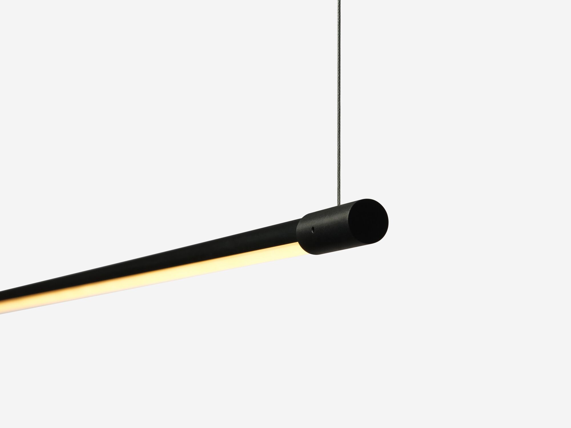 Slim black pendant lamp with light on detail view
